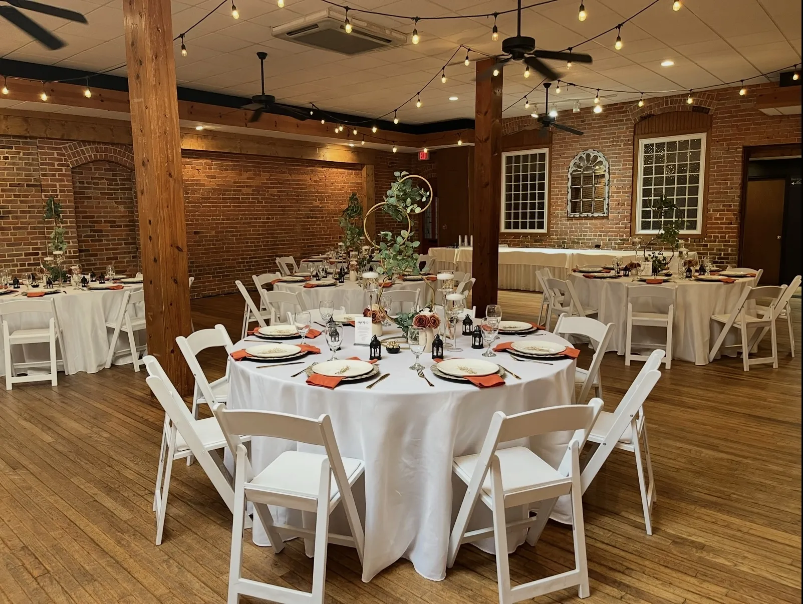 The Exchange's historic event space with exposed brick and hardwood floors